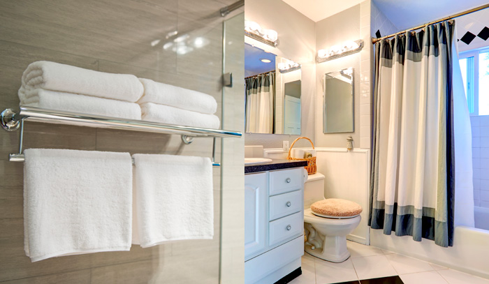 Bathroom scene with hanging and folded towels as well as a nice modern, bright bathroom